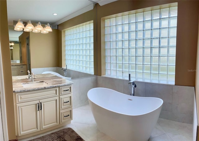 bathroom with tile walls, tile flooring, vanity, and a bath to relax in