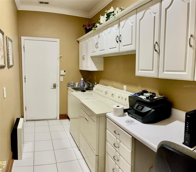 washroom featuring crown molding, sink, light tile flooring, separate washer and dryer, and cabinets