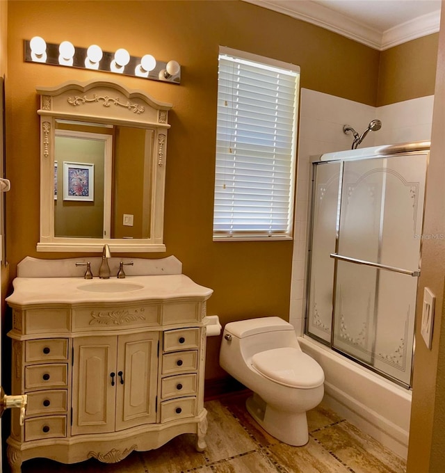 full bathroom with ornamental molding, combined bath / shower with glass door, toilet, and large vanity