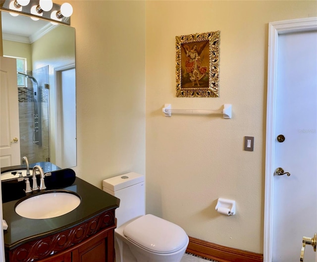 bathroom with crown molding, a shower with shower door, toilet, and vanity