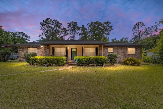 ranch-style house with a lawn