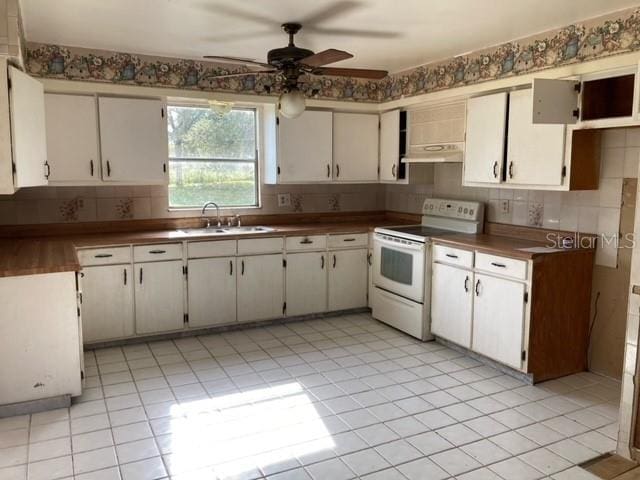 kitchen with sink, tasteful backsplash, white cabinetry, and electric stove