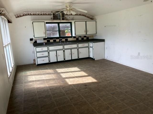 kitchen with tile flooring, plenty of natural light, ceiling fan, and white cabinets