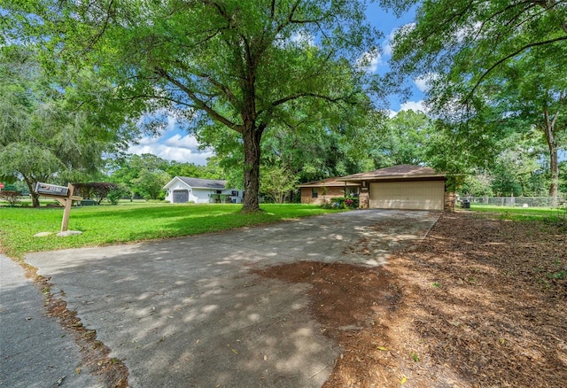 view of front of property featuring a garage and a front lawn