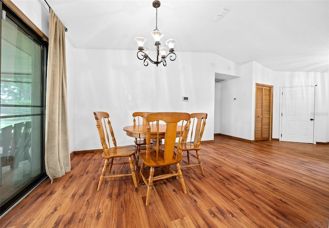 dining area with a notable chandelier, expansive windows, and dark wood-type flooring