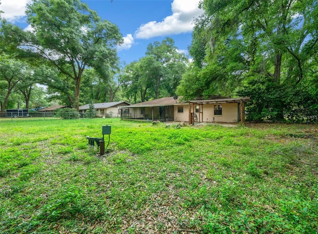 view of yard with a sunroom