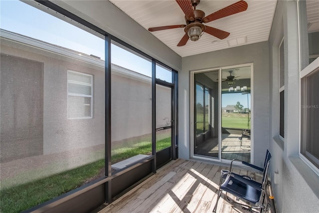 sunroom featuring ceiling fan