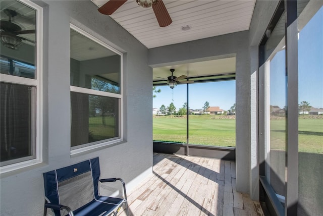 sunroom featuring ceiling fan and a wealth of natural light