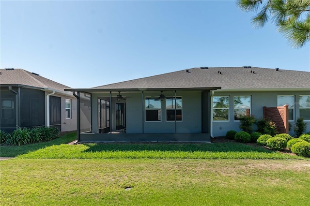 back of house featuring a patio, a yard, and ceiling fan