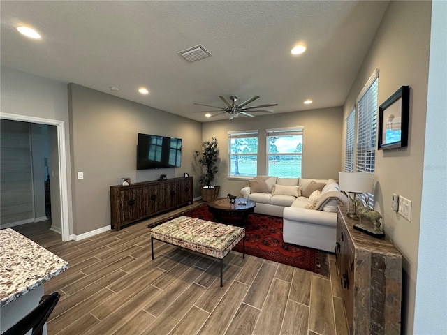 living room with ceiling fan and hardwood / wood-style flooring