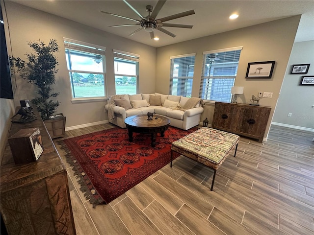 living room featuring ceiling fan and hardwood / wood-style floors