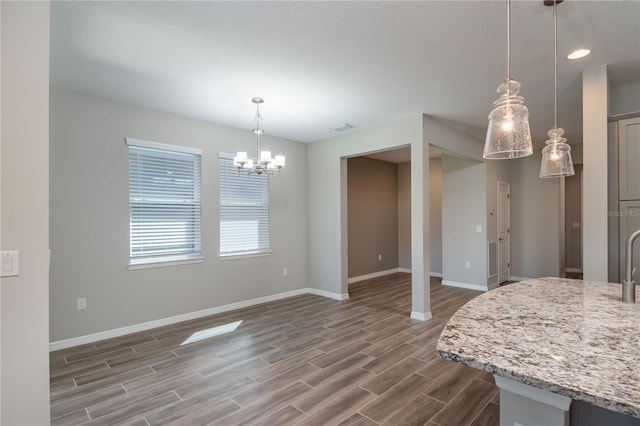 dining area featuring an inviting chandelier and dark wood-type flooring