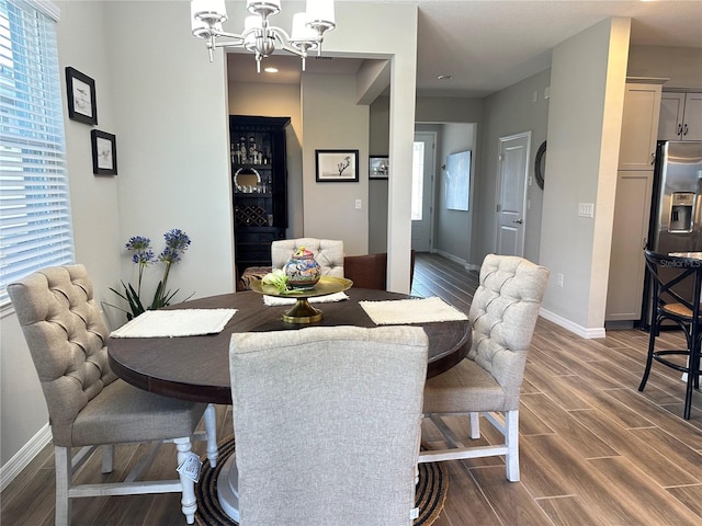 dining space featuring an inviting chandelier and dark wood-type flooring