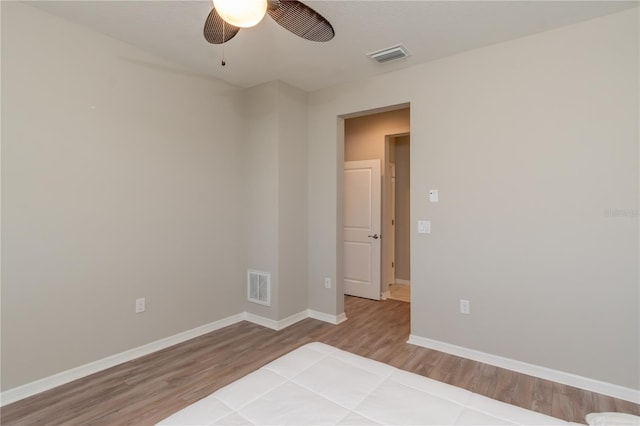 spare room with light wood-type flooring and ceiling fan