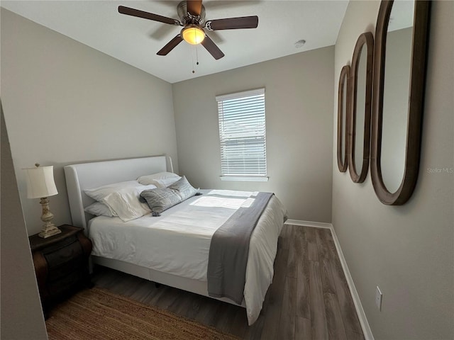 bedroom with dark wood-type flooring and ceiling fan