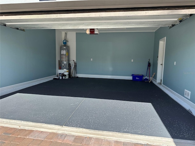 garage with a garage door opener and water heater