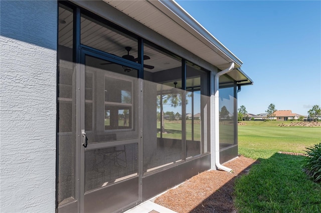 view of exterior entry with a yard