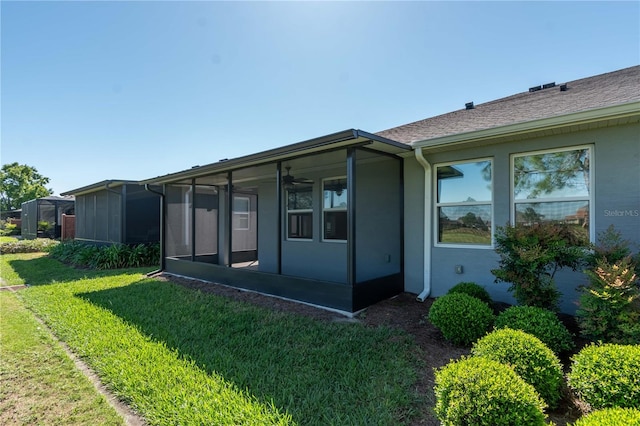 view of side of home with a yard and a sunroom