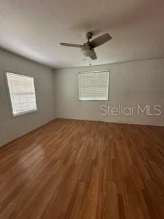 unfurnished room with ceiling fan and hardwood / wood-style flooring