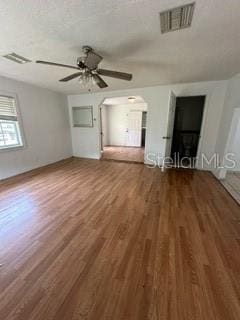 unfurnished bedroom with ceiling fan and hardwood / wood-style flooring