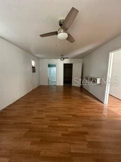 interior space with ceiling fan and dark wood-type flooring