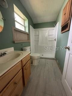 full bathroom featuring bathtub / shower combination, toilet, vanity, and wood-type flooring