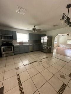 kitchen featuring appliances with stainless steel finishes, ceiling fan, and light tile floors