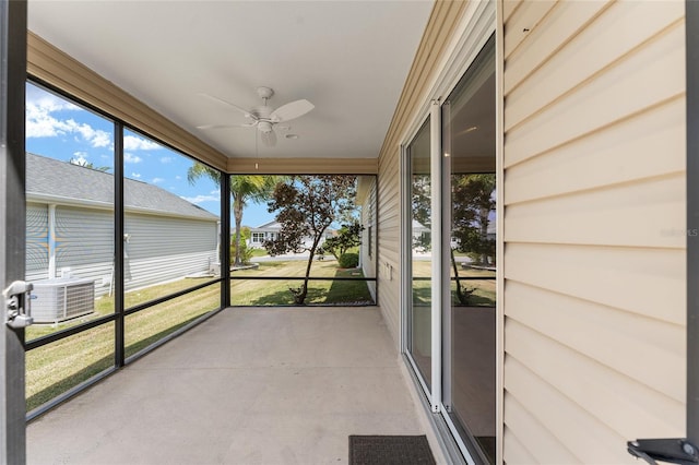 unfurnished sunroom with ceiling fan