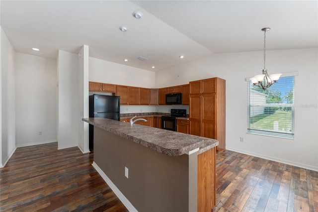 kitchen with vaulted ceiling, dark wood-type flooring, black appliances, pendant lighting, and a notable chandelier