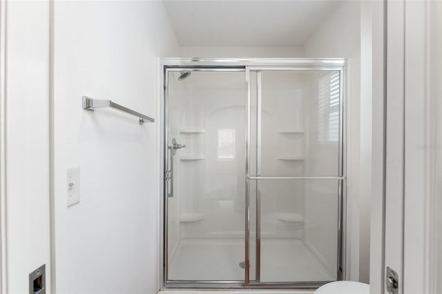 bathroom with a shower with shower door