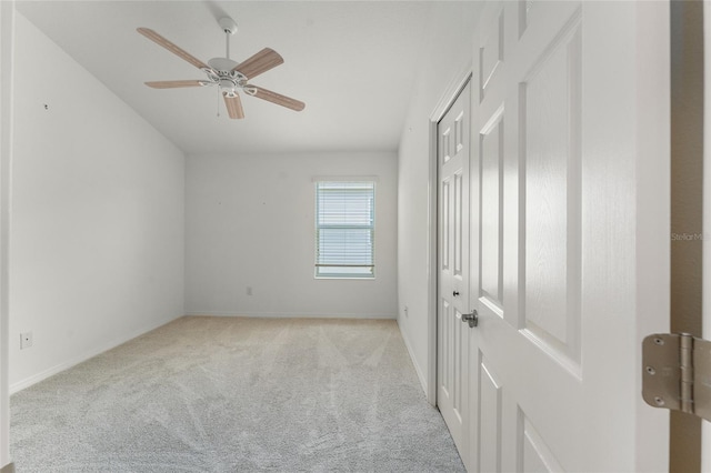 unfurnished bedroom featuring ceiling fan and light colored carpet