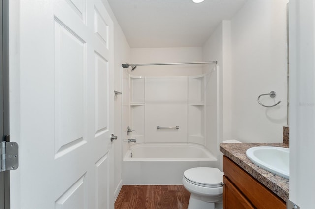 full bathroom with hardwood / wood-style flooring, vanity, toilet, and bathtub / shower combination