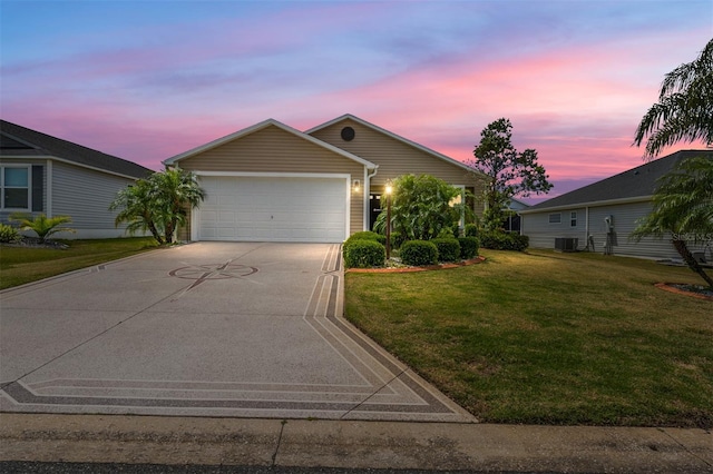 single story home featuring central AC, a yard, and a garage