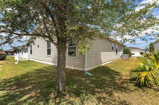 view of side of home with a lawn