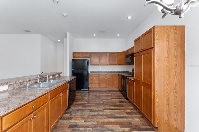 kitchen with dark wood-type flooring, sink, and black appliances