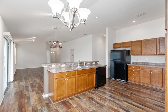 kitchen with sink, hanging light fixtures, an inviting chandelier, a kitchen island with sink, and black appliances