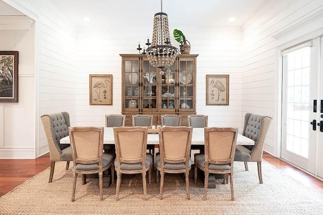 dining area with a notable chandelier and hardwood / wood-style flooring