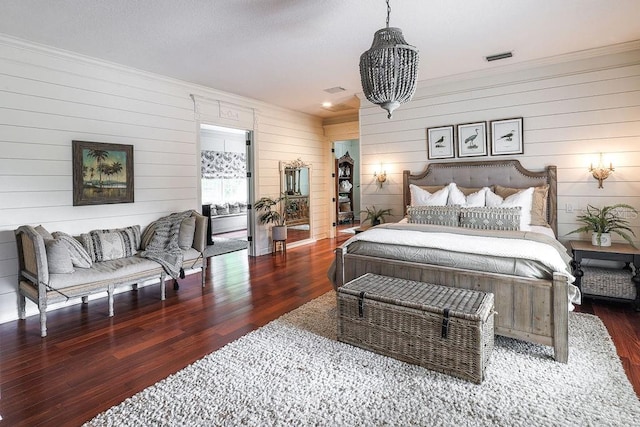 bedroom featuring dark wood-type flooring and wooden walls