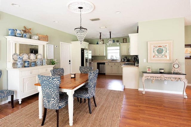 dining space featuring hardwood / wood-style floors and sink