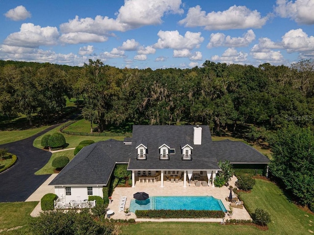 back of property featuring a yard and a patio