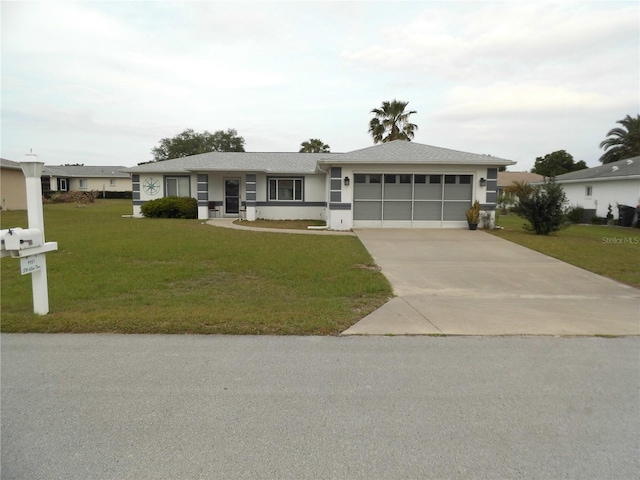 ranch-style house featuring a garage and a front lawn