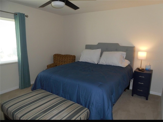 bedroom with light colored carpet and ceiling fan