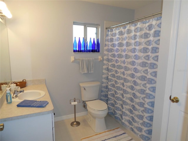 bathroom with tile floors, vanity, and toilet