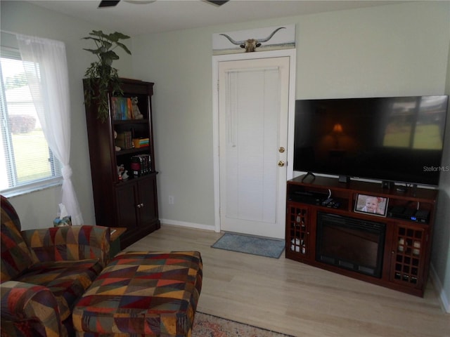 living room featuring ceiling fan and light wood-type flooring