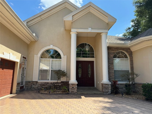 entrance to property featuring a porch and french doors