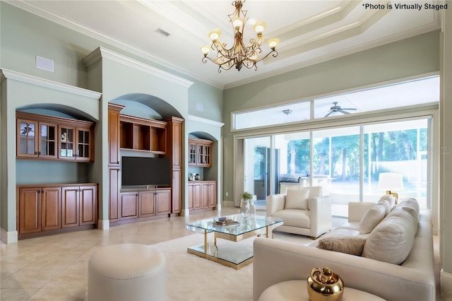 tiled living room with a towering ceiling, ceiling fan with notable chandelier, a raised ceiling, and ornamental molding