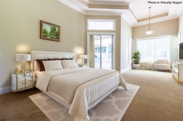 bedroom with access to exterior, carpet, a towering ceiling, and crown molding