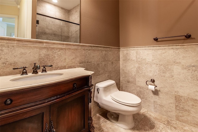 bathroom featuring vanity, toilet, and tile walls