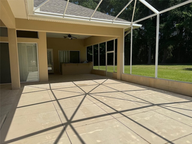 unfurnished sunroom with ceiling fan