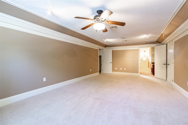 carpeted spare room with ceiling fan and crown molding